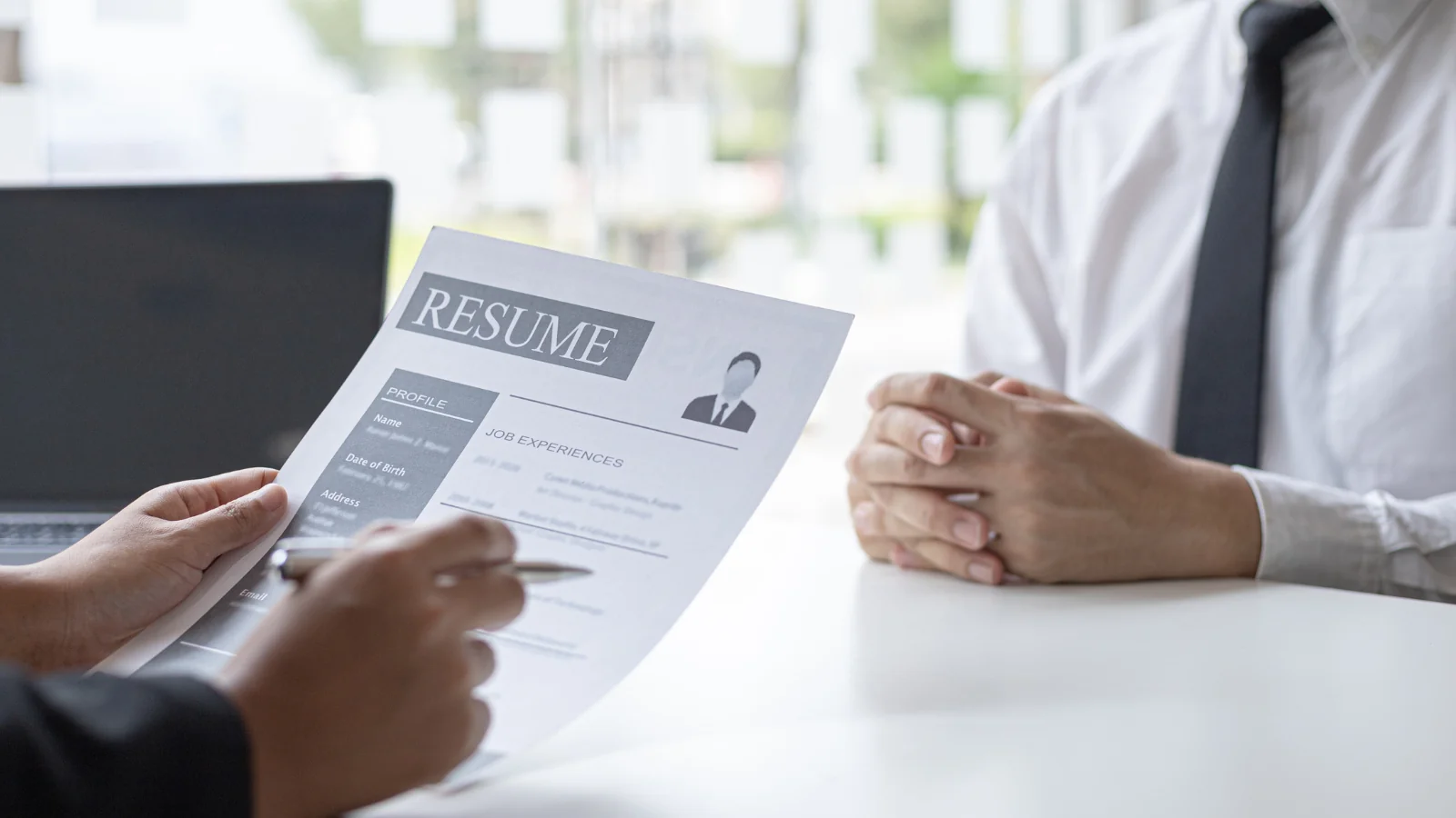 Hiring manager reviewing cover letter with proper address formatting and contact details